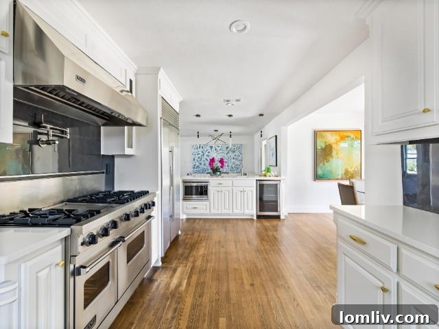 Detail view of the sleek kitchen island featuring a stainless steel graphite sink and quartz countertops.