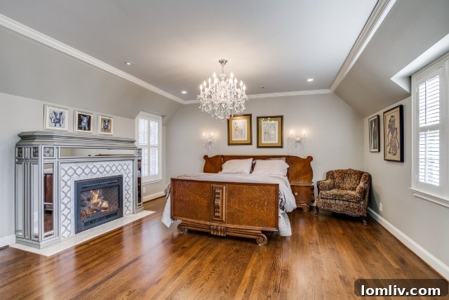 The luxurious principal suite featuring an Art Deco-inspired mirrored fireplace and access to a second-floor deck overlooking the expansive backyard.