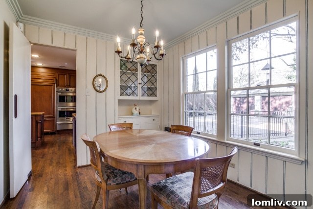 A pristine, light-filled kitchen space showcasing ample counter space and elegant cabinetry.