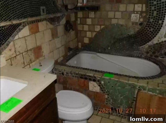 Interior view of an unfinished bathroom with exposed plumbing and rustic elements