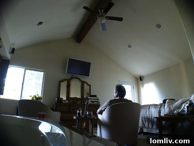 Unusual bedroom staging with a man staring into space