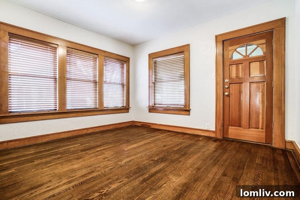Elegant living room with a cozy brick fireplace and original hardwood floors at 5921 Vanderbilt