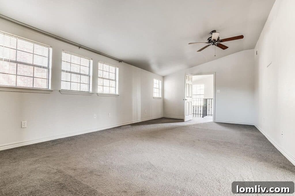 Luxurious primary bathroom with dual shaker-style vanity and privacy glass blocks