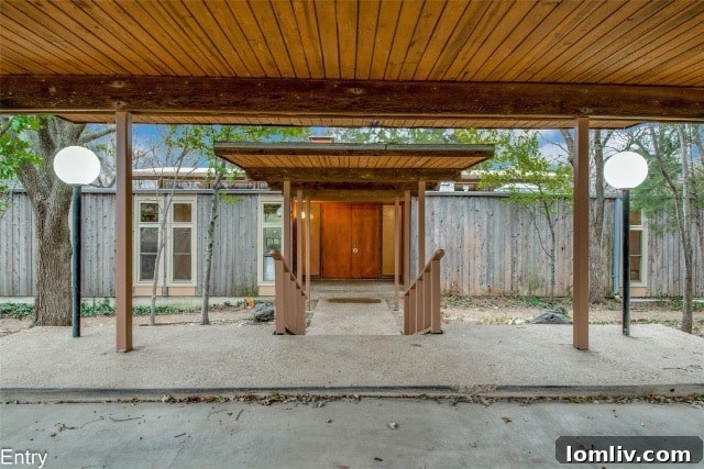 Mid-Century Modern home exterior showing extensive wood paneling and carport