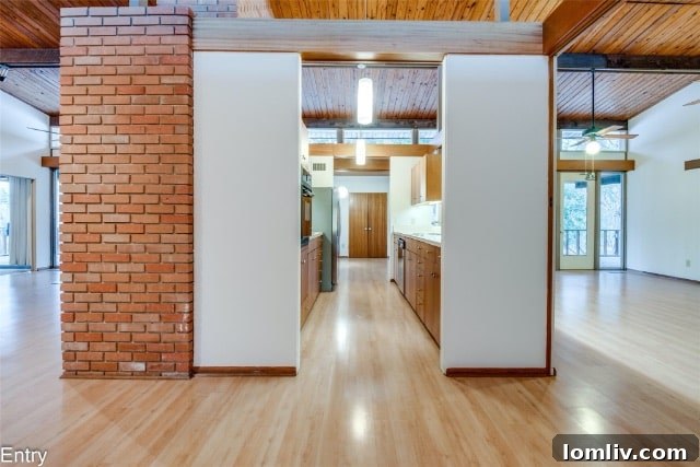 Interior view of Mid-Century Modern home showing wood beams and large windows
