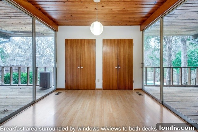 Hallway with wood paneling and natural light