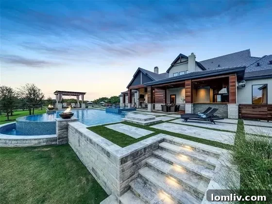 A closer view of the stunning outdoor pool area with surrounding patios and landscaping.