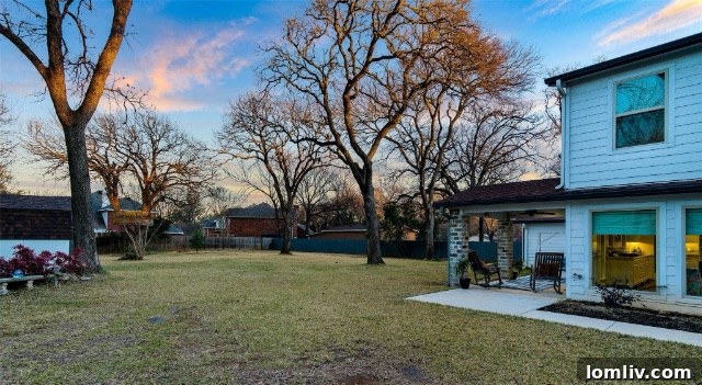 Lush, spacious backyard with mature trees and green lawn