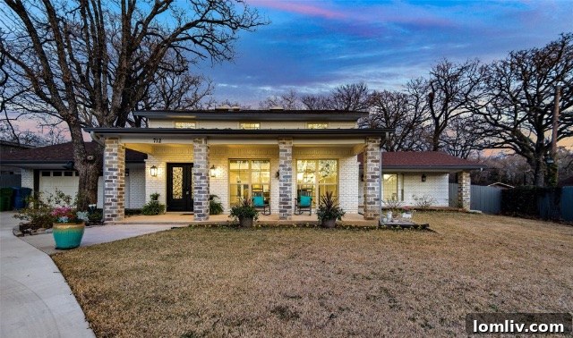 Exterior view of the ranch home with lush landscaping