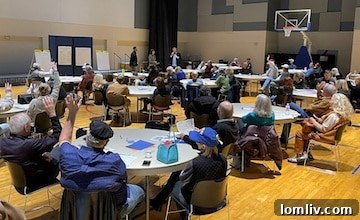 Numerous hands raised in strong opposition to apartment proposals at the LBJ Corridor meeting.