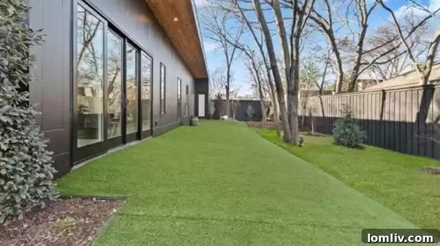 Rear view of the modern home showing the backyard with a pool