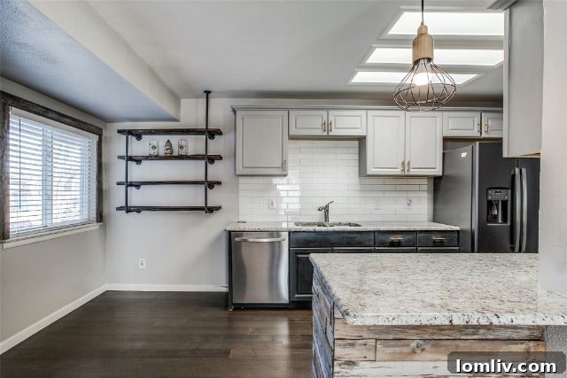 Bright, open-concept kitchen with white subway tile and updated appliances