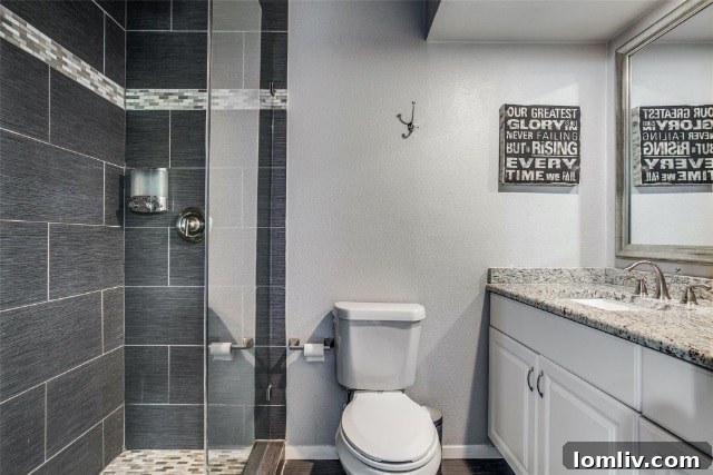 Another view of the pristine bathroom featuring contemporary finishes and bright lighting