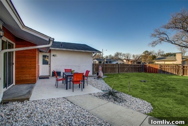 Rear view of the East Dallas home showcasing the patio off the primary suite