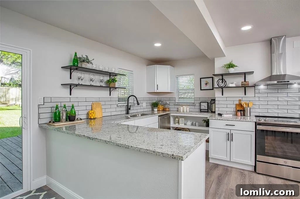 Modern kitchen with shaker cabinets, granite countertops, subway tile backsplash, stainless steel appliances, and mounted wall shelves in the Carrollton home.
