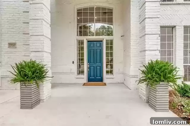 Elegant entrance and manicured landscaping of a custom-built luxury home in Southlake, TX