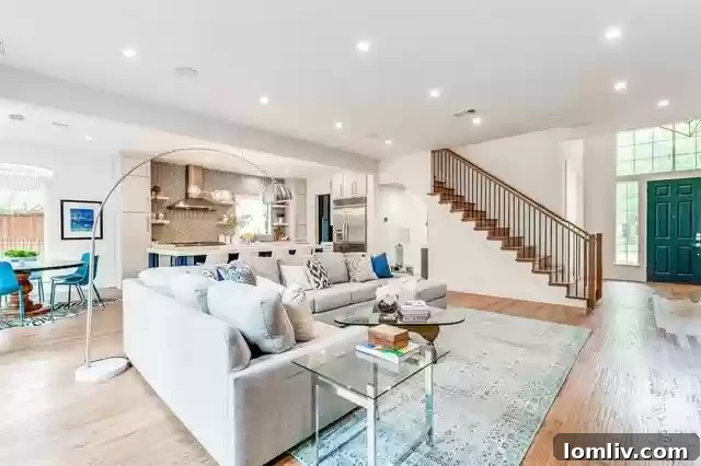 Spacious and bright open-concept living area with modern furnishings and a fireplace in a Southlake luxury home