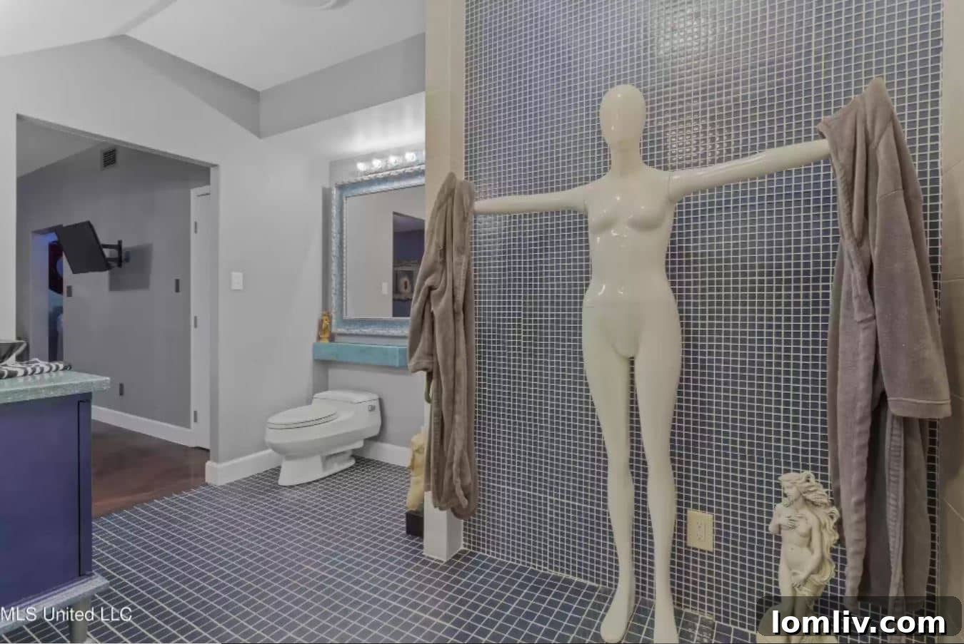 Artistic display of a headless mannequin in a bathroom setting, continuing the unique home aesthetic.