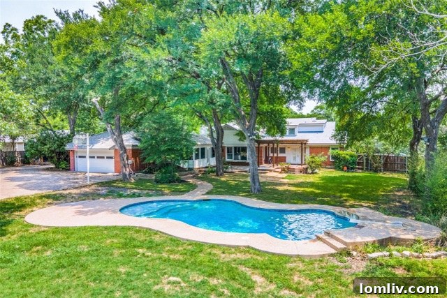 Lush green lawn and mature trees in the private backyard