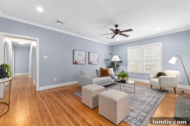 Elegant living area featuring abundant natural light, a cozy fireplace, and classic architectural elements characteristic of a Tudor home's interior