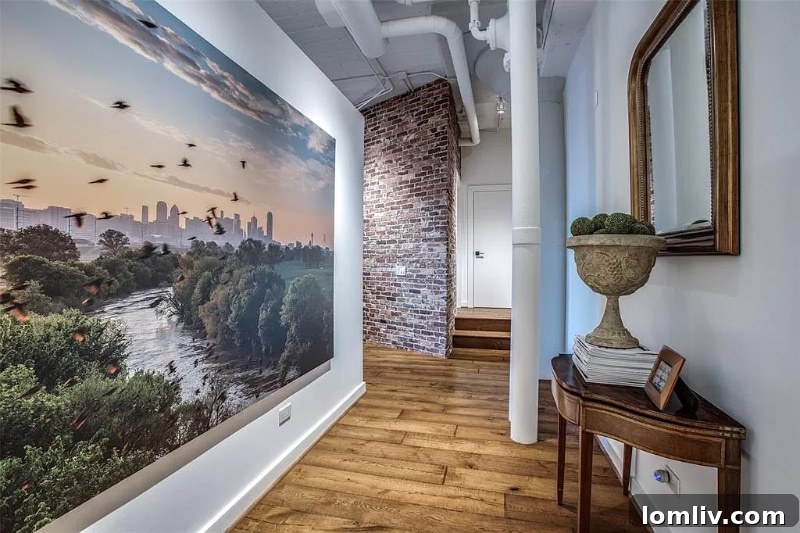 Grand entrance to a luxury loft with Dallas skyline art