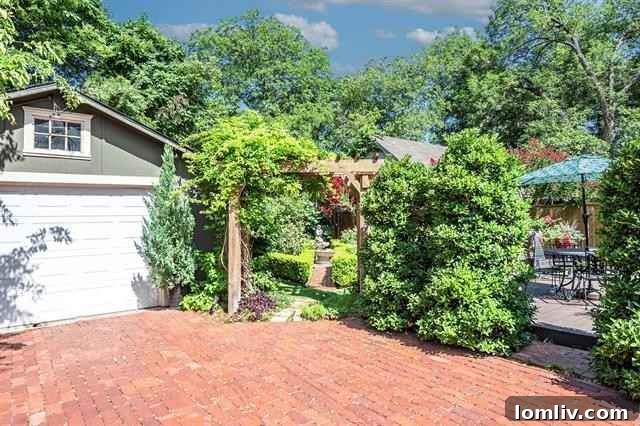 Lush green pathways and sculpted hedges in the meticulously maintained garden of 1812 5th Avenue