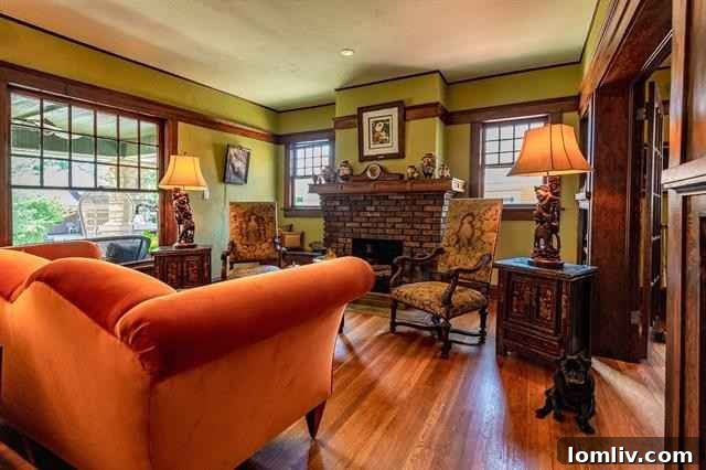 Elegant living room with meticulously restored hardwood floors and mahogany trim in historic Fort Worth house