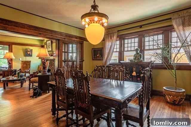 Cozy dining area in Fairmount home showcasing period details and deep mustard walls contrasting mahogany woodwork