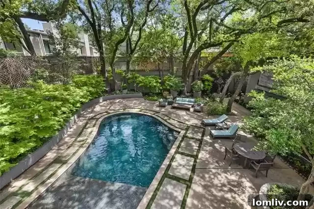 An Extraordinary Home: Elegance Crafted for the Discerning Spirit 14 Luxurious backyard oasis at 3610 Congress with pool tanning ledge, water feature, and mature oak trees.