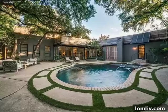 An Extraordinary Home: Elegance Crafted for the Discerning Spirit 15 Serene outdoor living space at 3610 Congress, featuring a stone walkway and lush landscaping under a natural canopy.