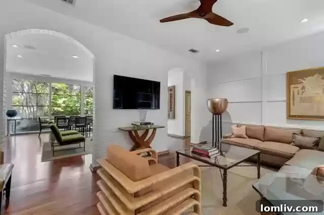 An Extraordinary Home: Elegance Crafted for the Discerning Spirit 8 Modern and comfortable den area, providing a serene retreat in this luxury Dallas residence.