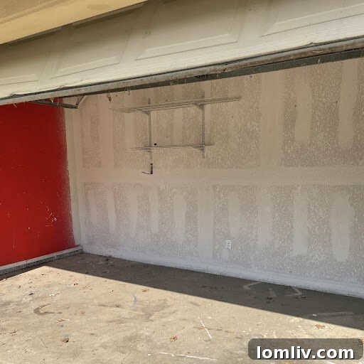 Garage conversion with an intact garage door and empty space, indicating unpermitted work