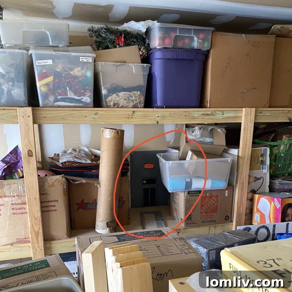 Cluttered garage storage blocking an electrical panel, a safety hazard