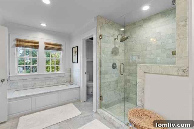 Primary spa bath with Carrara marble floors, shower, and wood-paneled accents