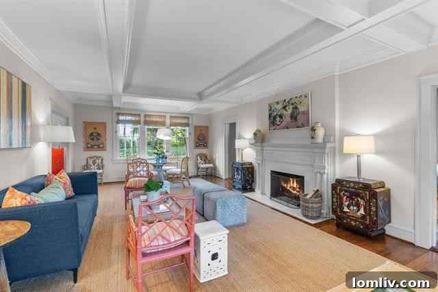 Spacious living room with fireplace and coffered ceilings in Colonial Revival home