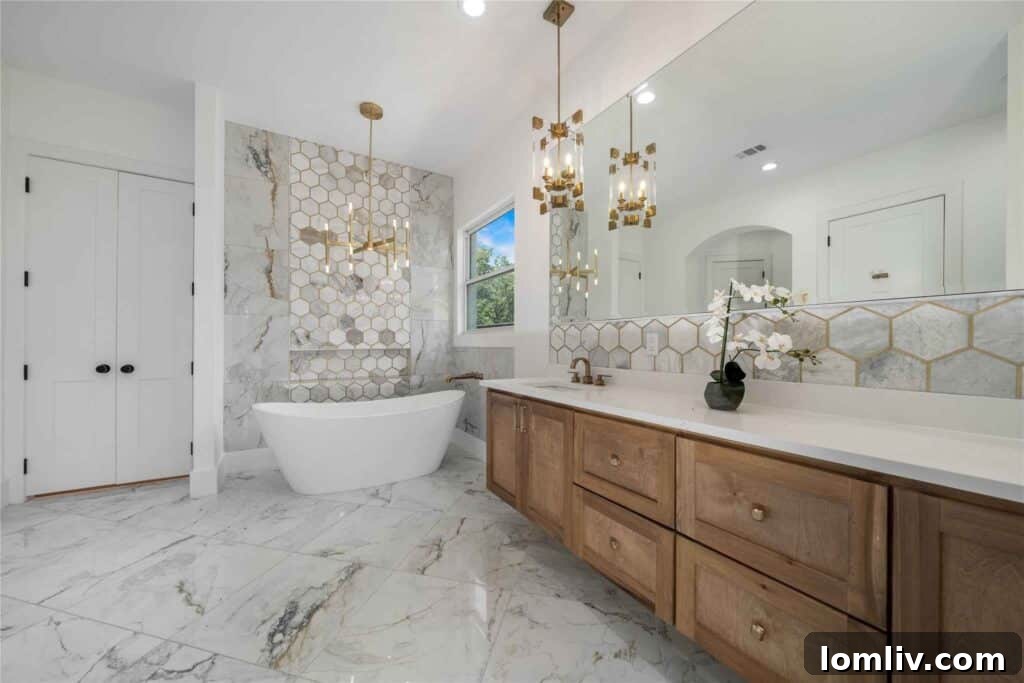 Spa-like en-suite bathroom with large slab marble floors and freestanding slipper tub