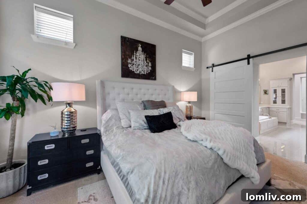 Luxurious primary bathroom with soaking tub, rainfall shower, and custom cabinetry