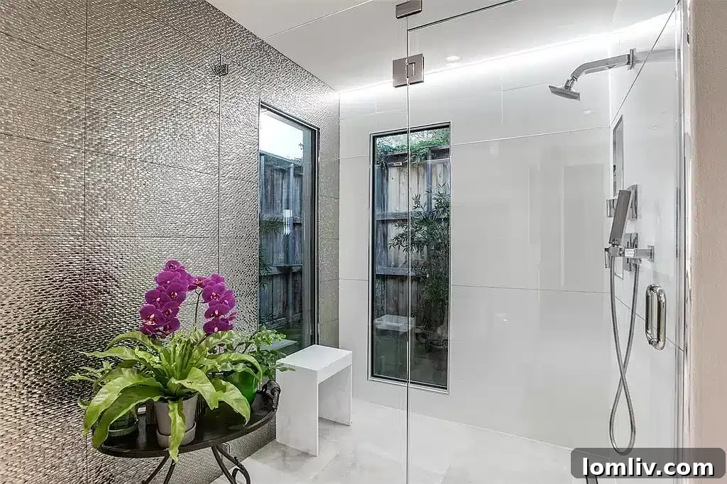 Remodeled primary bathroom with large shower and quartz countertops