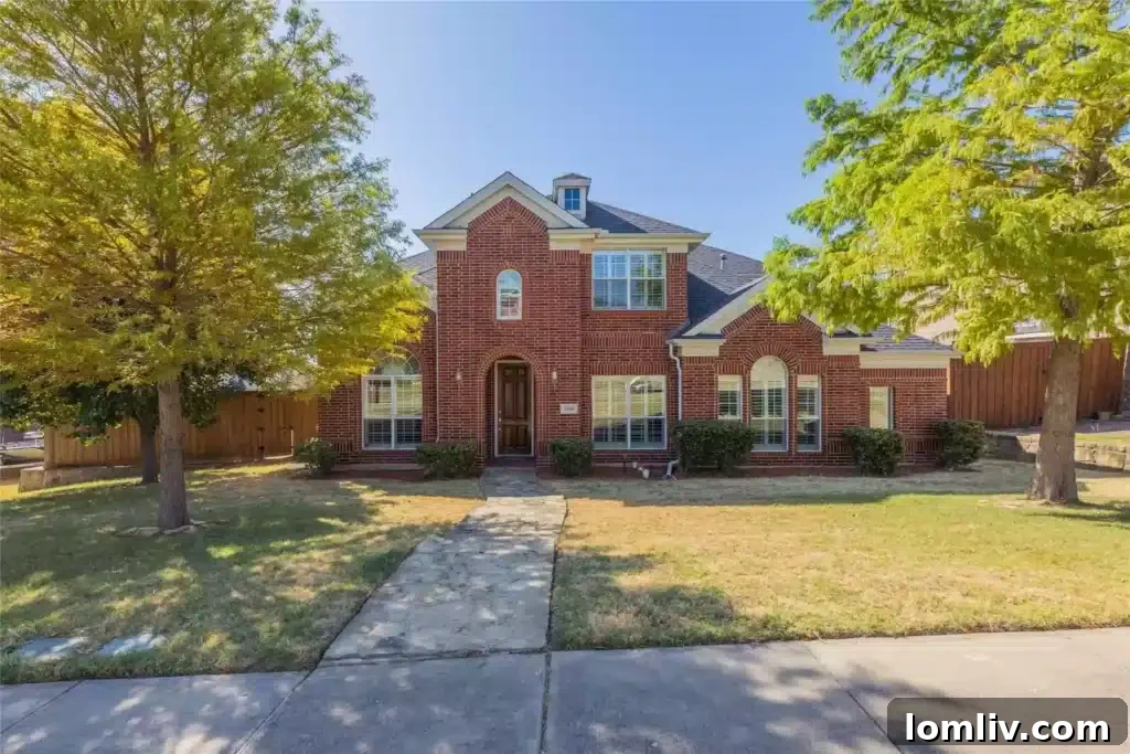 Stunning red brick home with mature landscaping at 2450 Chesapeake Drive in Garland, Texas