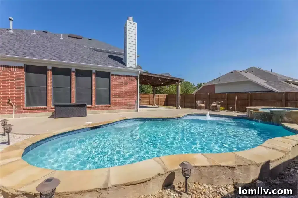 Spacious covered patio overlooking the pool, perfect for outdoor entertaining