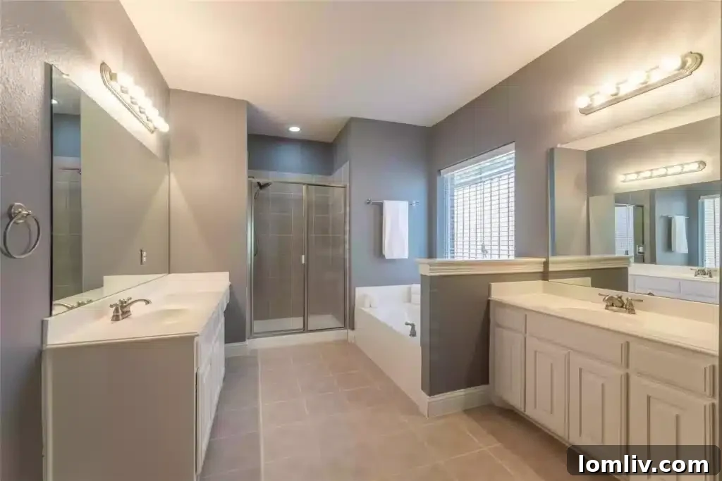 Well-appointed primary bathroom with dual vanities and ample storage