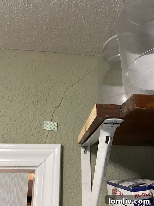 Blue Painter's Tape on a Foundation Crack