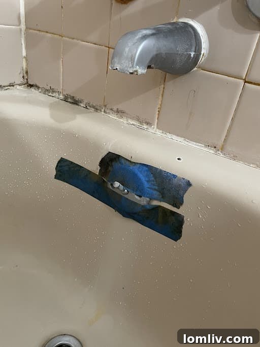Blue Painter's Tape on a Bathtub Drain