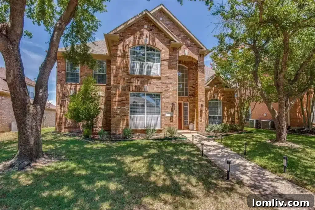 A contemporary kitchen featuring pristine white cabinetry, quartz countertops, and stainless steel appliances.