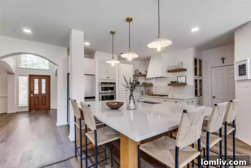The stunningly renovated kitchen after its 10-year transformation, showcasing modern finishes and an open concept.