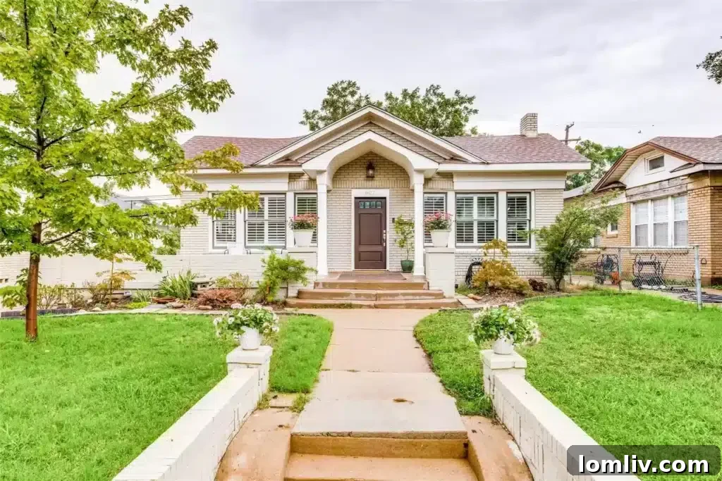 Charming 1923 Craftsman Bungalow Exterior in Oak Cliff, Dallas, showcasing classic architecture and lush landscaping.