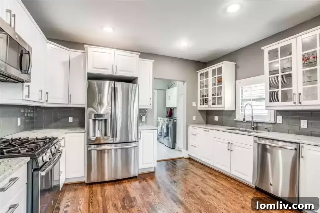 Modern kitchen with granite countertops, stainless steel appliances, and a functional breakfast bar, perfect for entertaining.