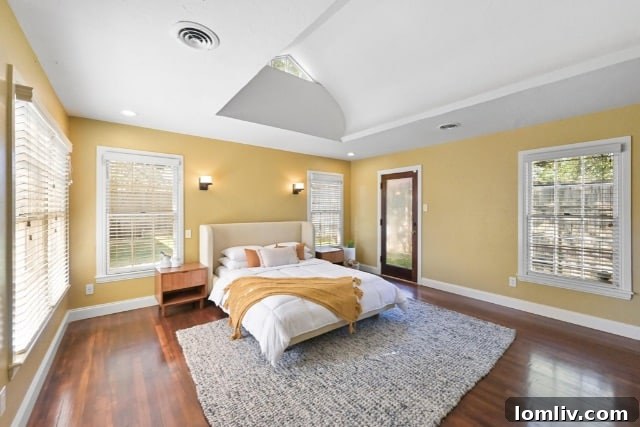 Spacious and elegantly designed primary bedroom, offering ample light and comfort.