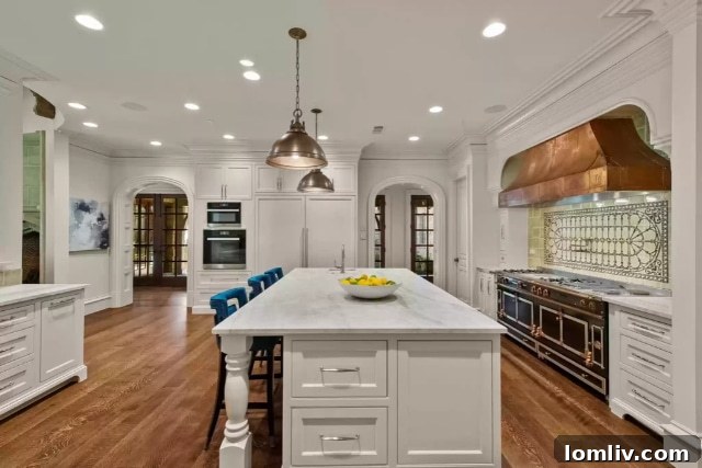 Gourmet kitchen with La Cornue range, Miele coffee maker, and Taj Mahal quartzite island