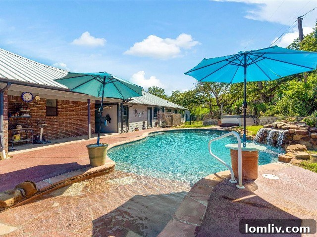 Gorgeous shared pool with beach entry and waterfall between the two homes in Burleson.